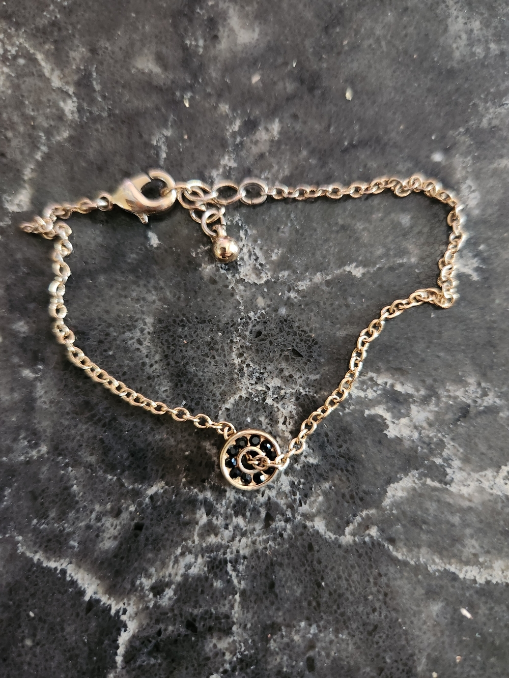 Delicate Gold-Tone Circle Pendant Bracelet with Black Accents